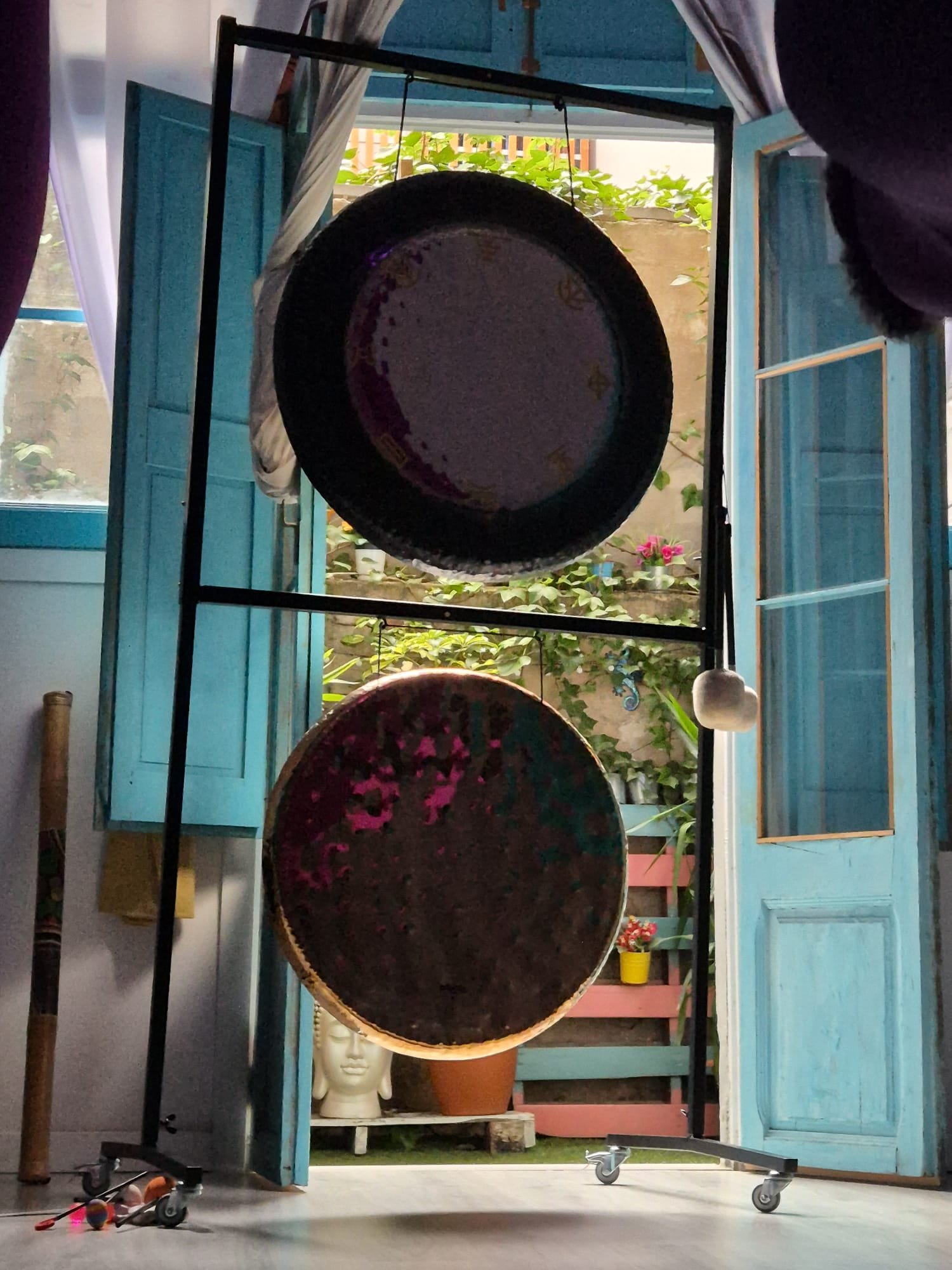 Gongs by window with natural light