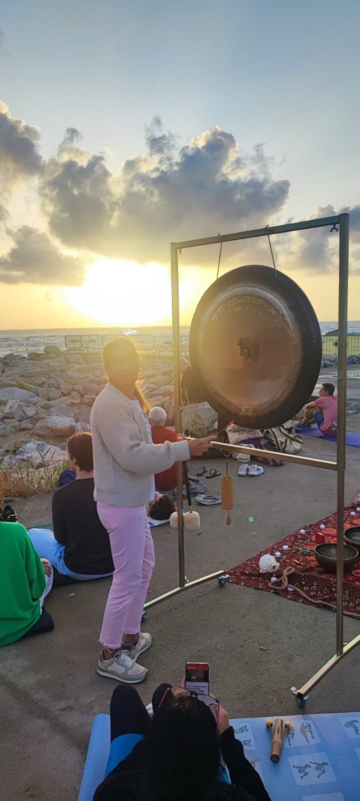 Montse playing gong at sunset