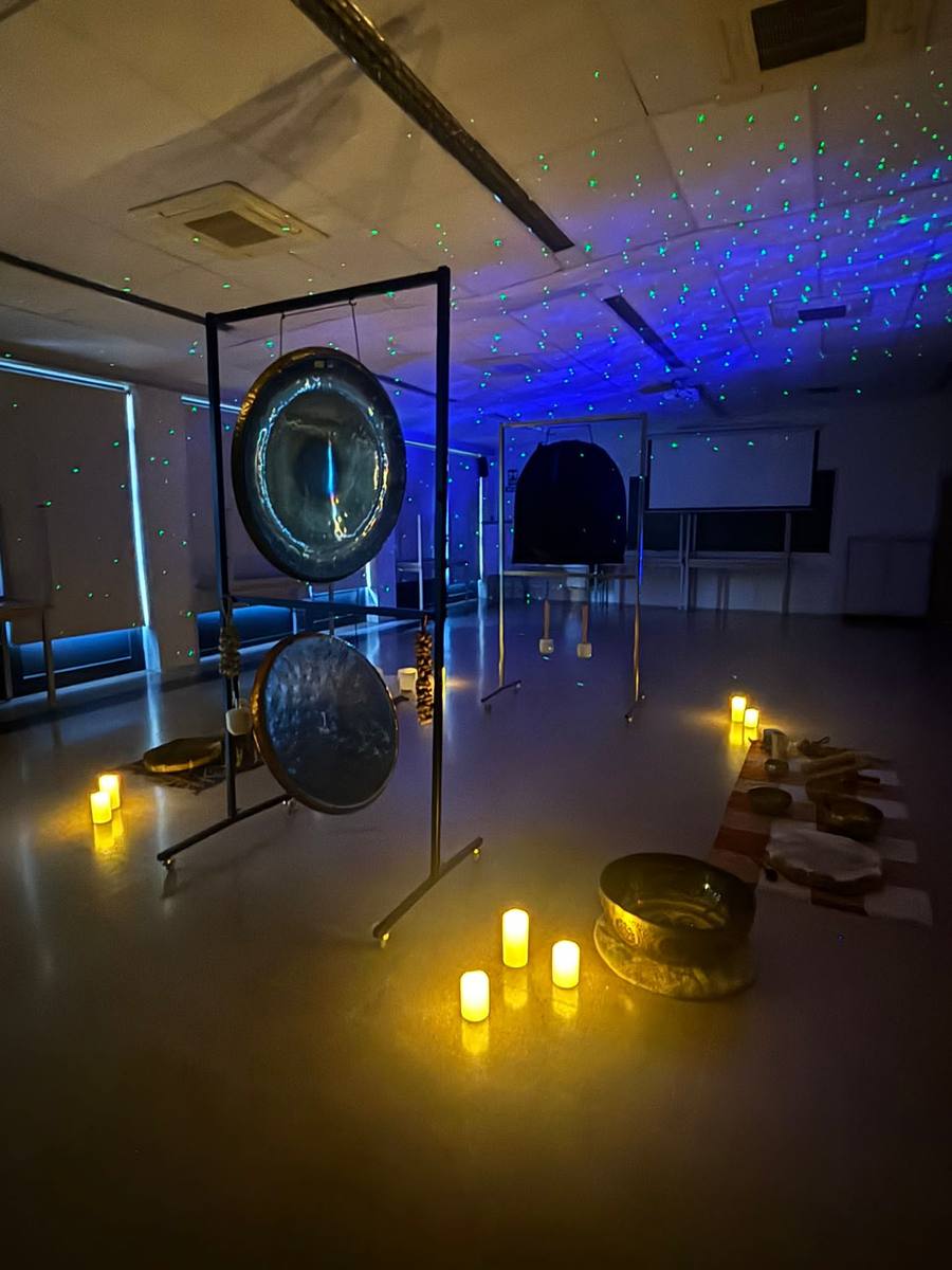 Sound bath space prepared with gongs and candles