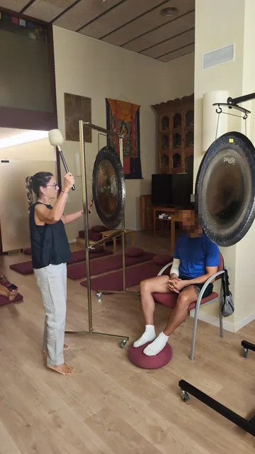 One-to-one sound bath: Montse Terradas plays the planetary gong beside a seated person