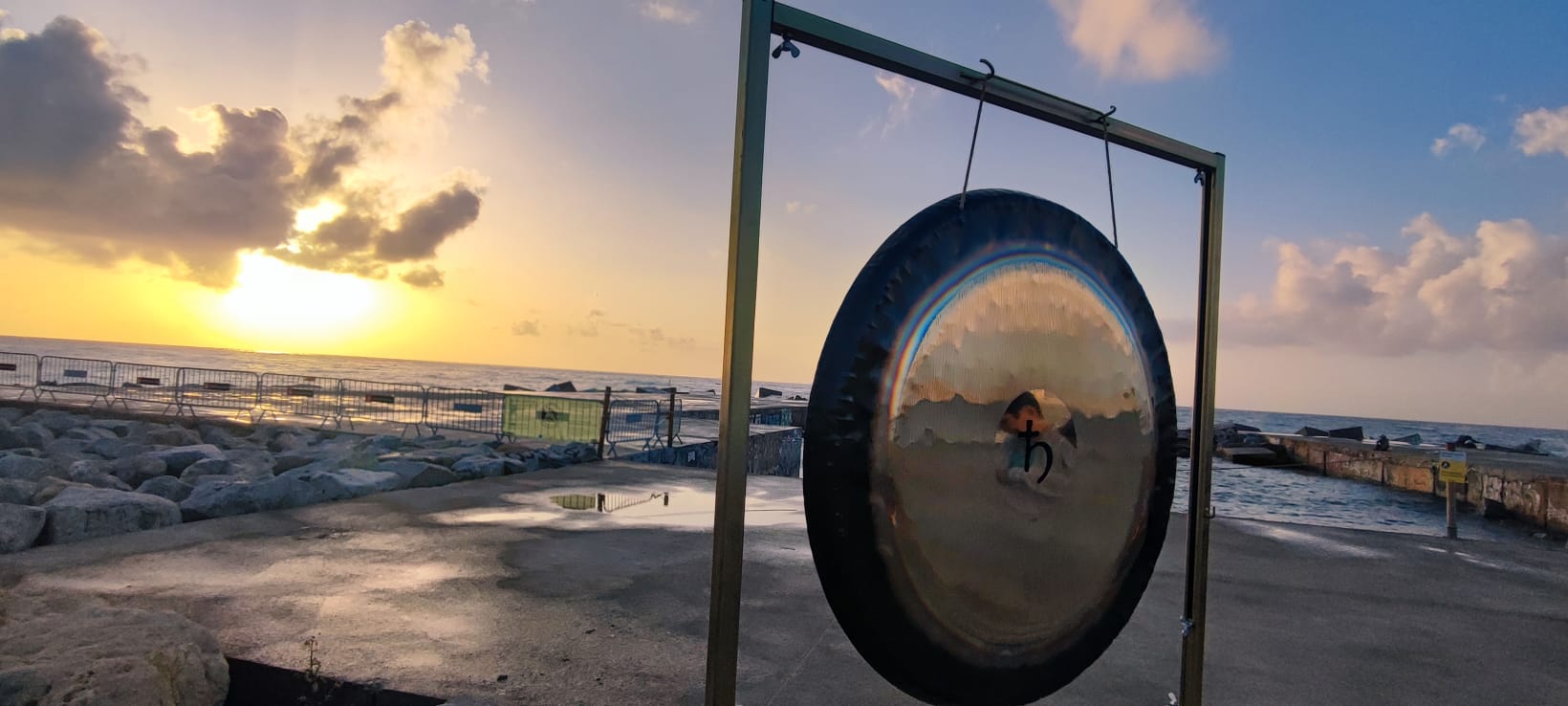 Gong facing the sea at sunset